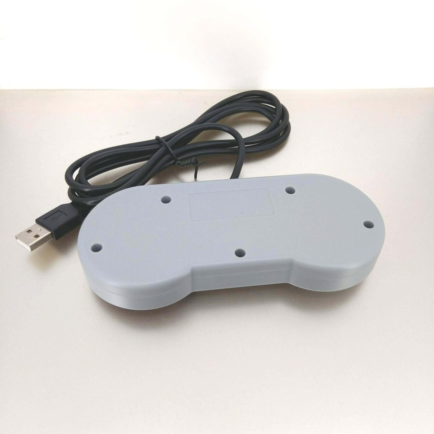 USB retro gaming controller for Raspberry Pi and PC, featuring a classic gamepad design with a connecting cable.