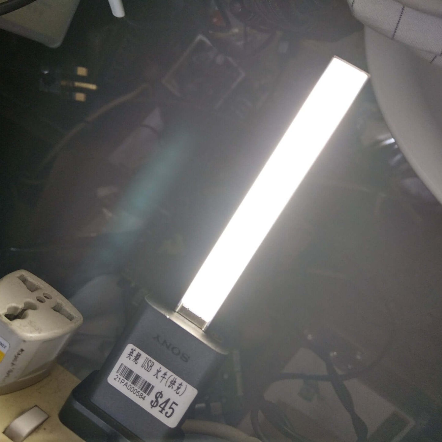 Portable USB Stick LED Light illuminating a workspace, featuring a compact design and bright, dimmable touch switch functionality.