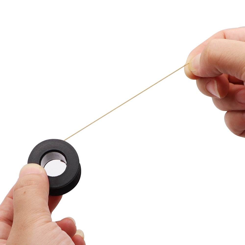 Person holding a spool of 0.1mm soldering wire, showcasing its use for motherboard repair and maintenance.