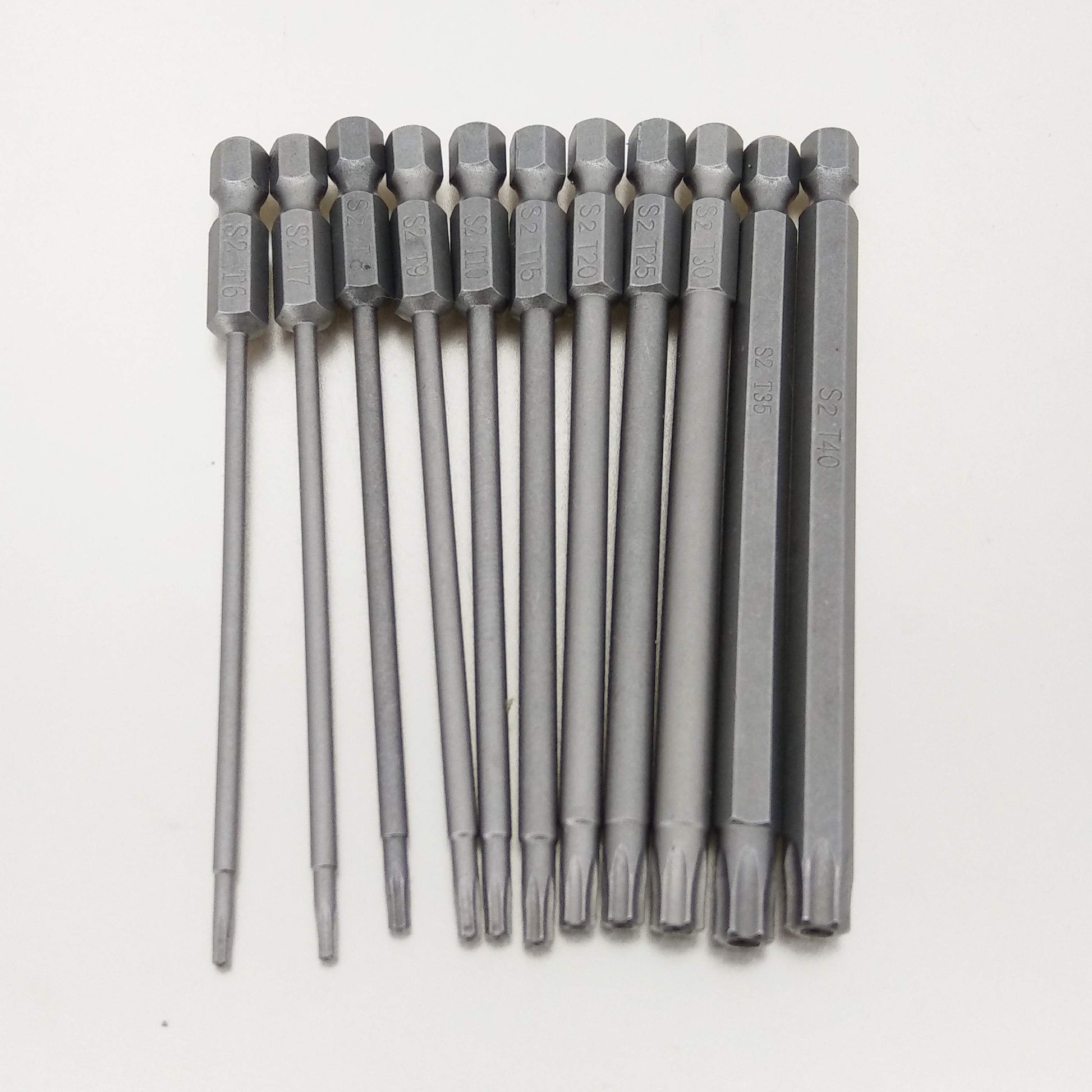 The full 11-piece set of 100mm magnetic S2 steel Torx screwdriver bits laid out in a row to show their full length.