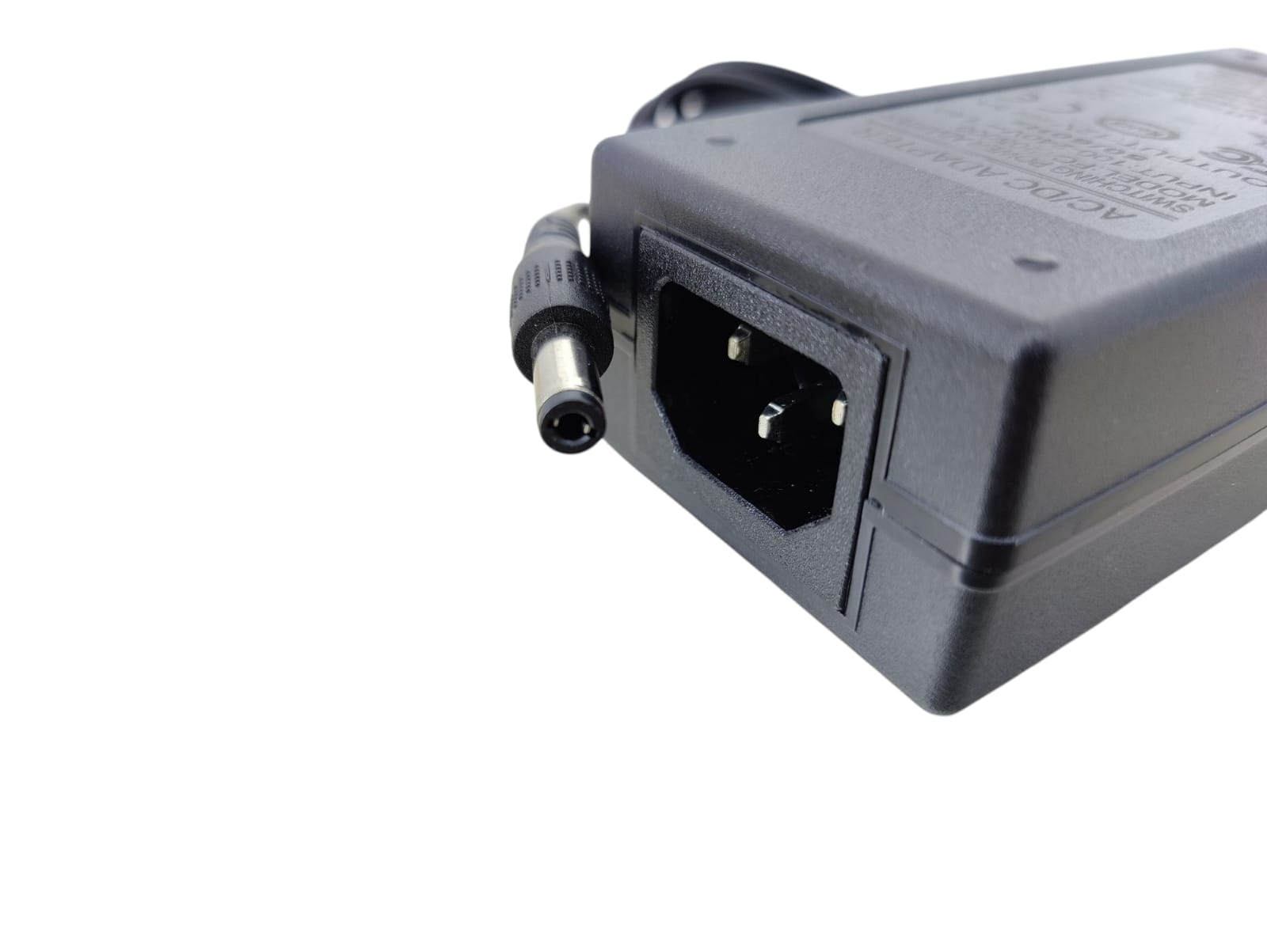 Close-up of a 12V 5A universal AC/DC power adapter showing the plug and power input port.