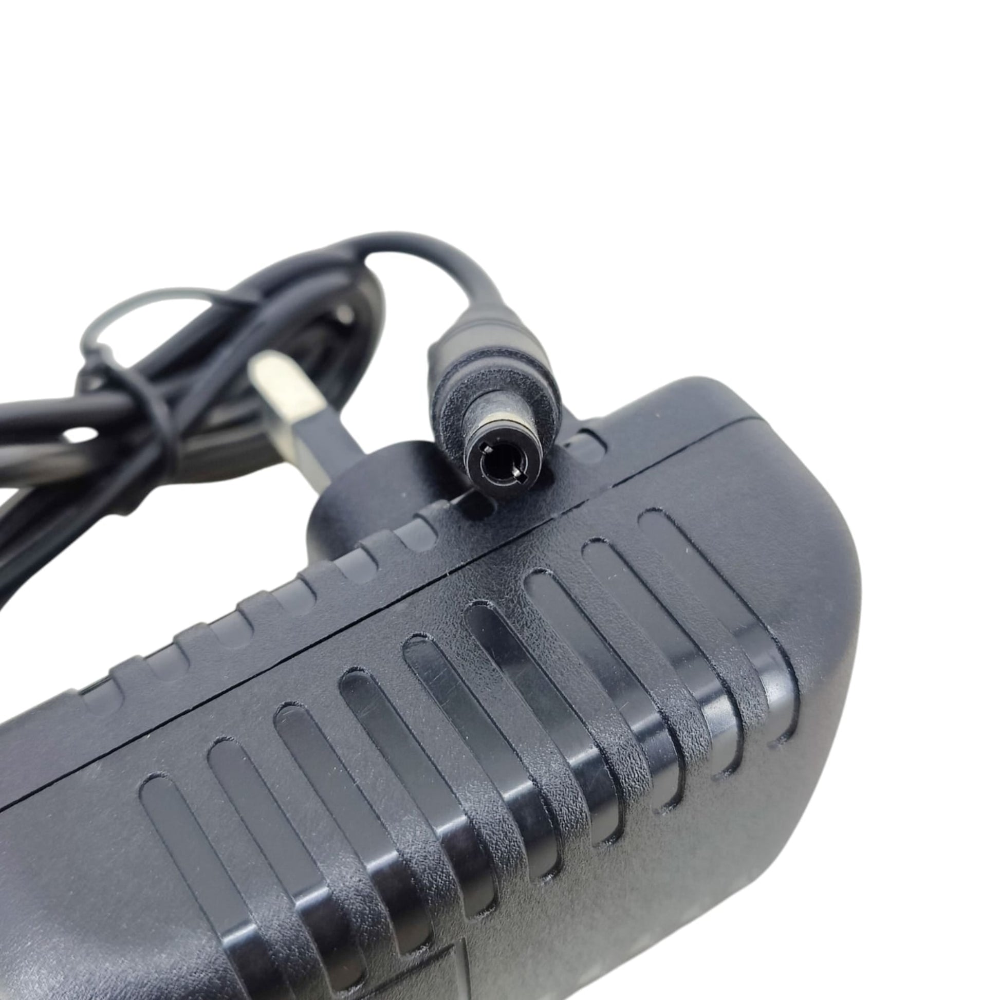 Close-up macro shot of the 5.5mm x 2.1mm DC barrel connector plug for the 28V 1A power adapter.