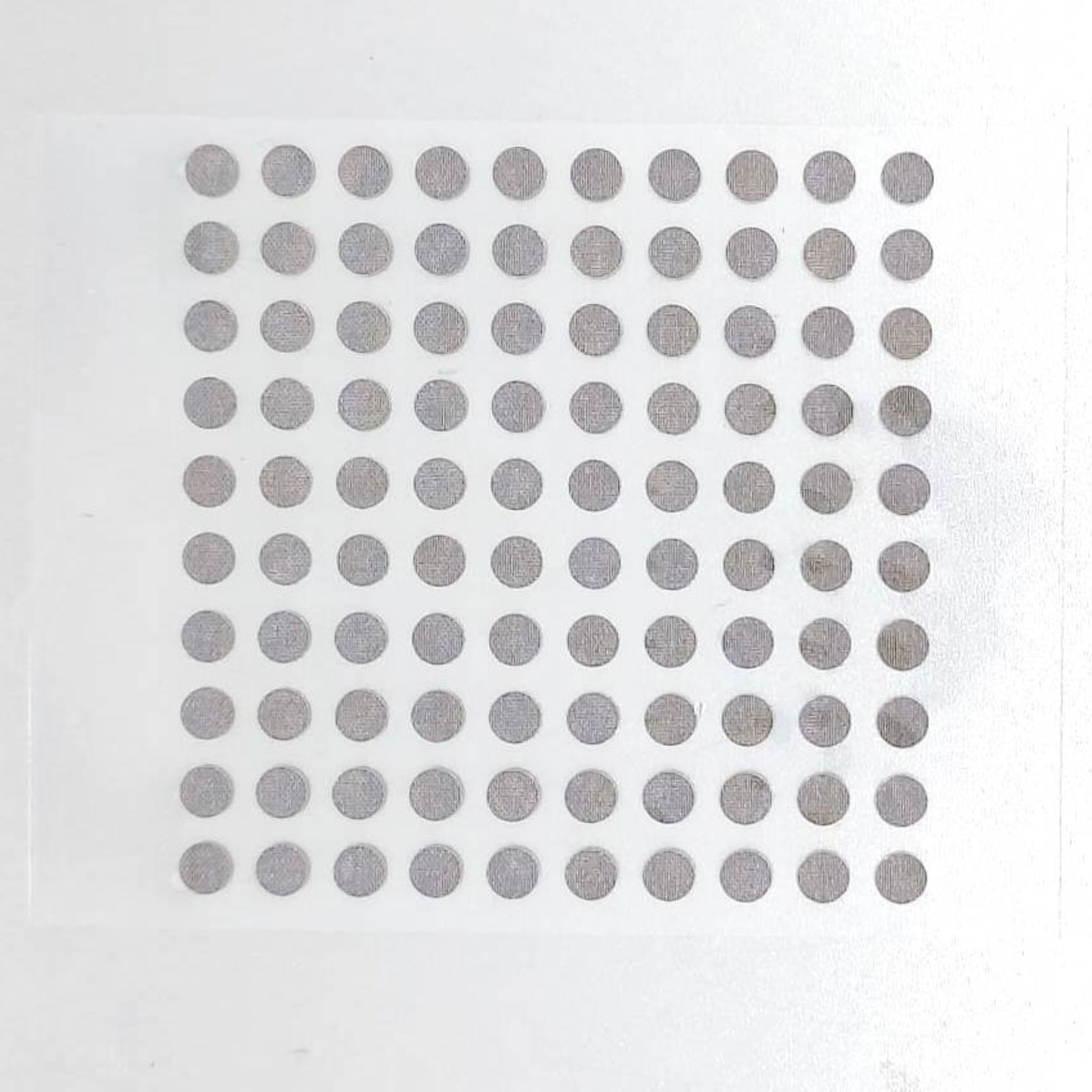 Full sheet of self-adhesive conductive replacement pads for electronic repair.