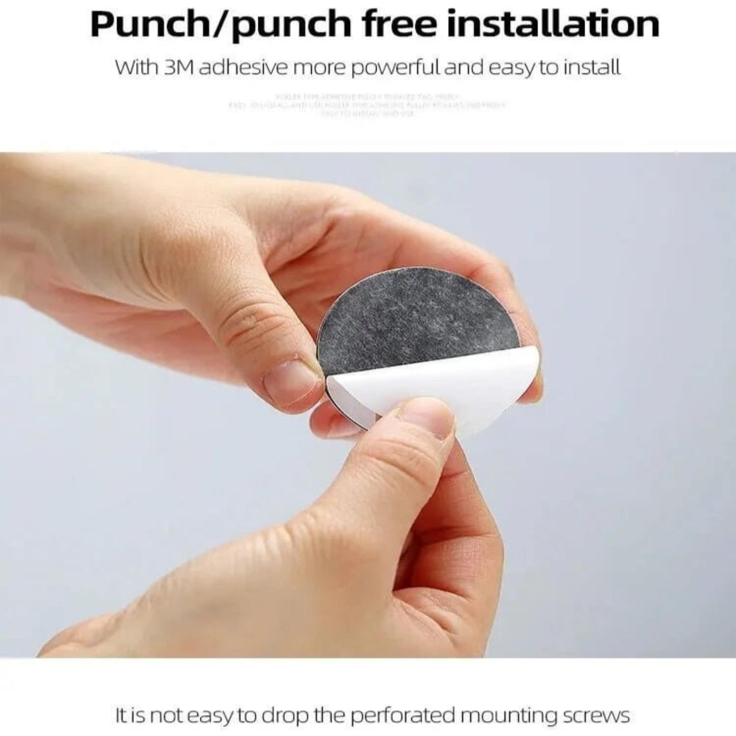 Hands peeling off the 3M adhesive backing from a self-adhesive ball wheel for punch-free installation on furniture.