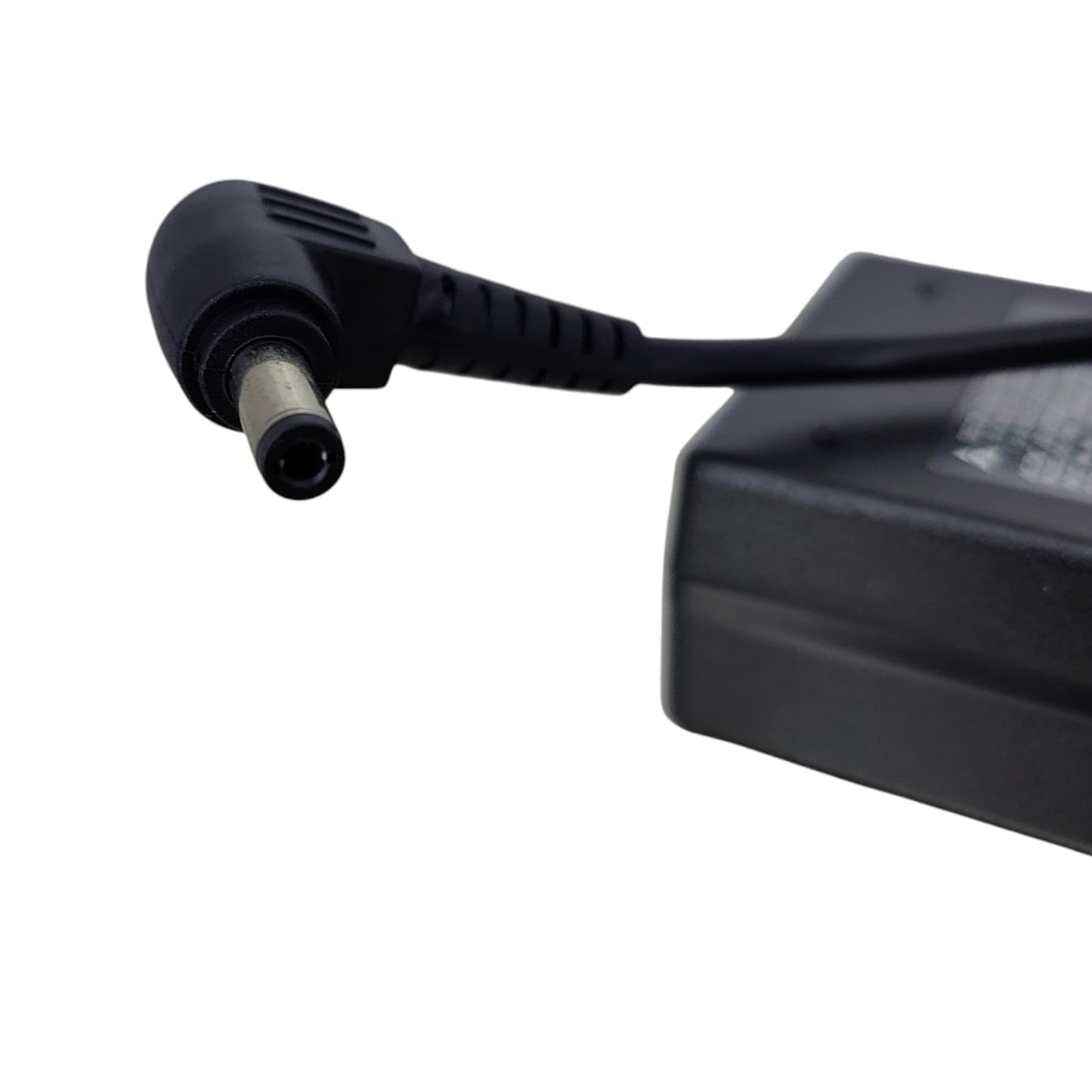 Detail shot of the 5.5mm x 2.5mm right-angle connector tip for laptop power supply.