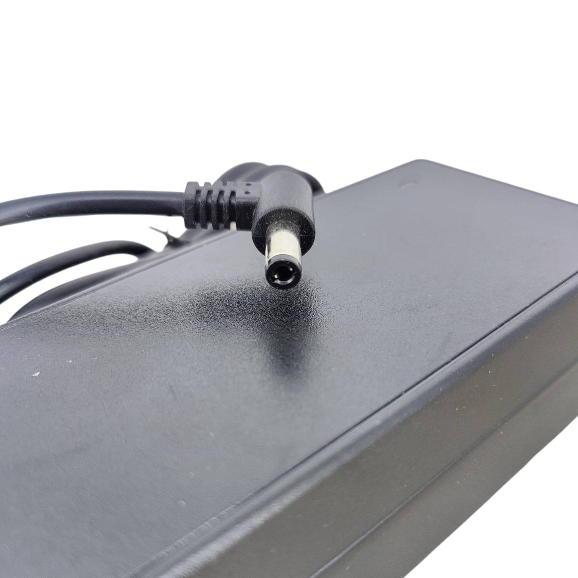 Detail shot of the 5.5mm x 2.5mm right-angle DC connector with ferrite core.