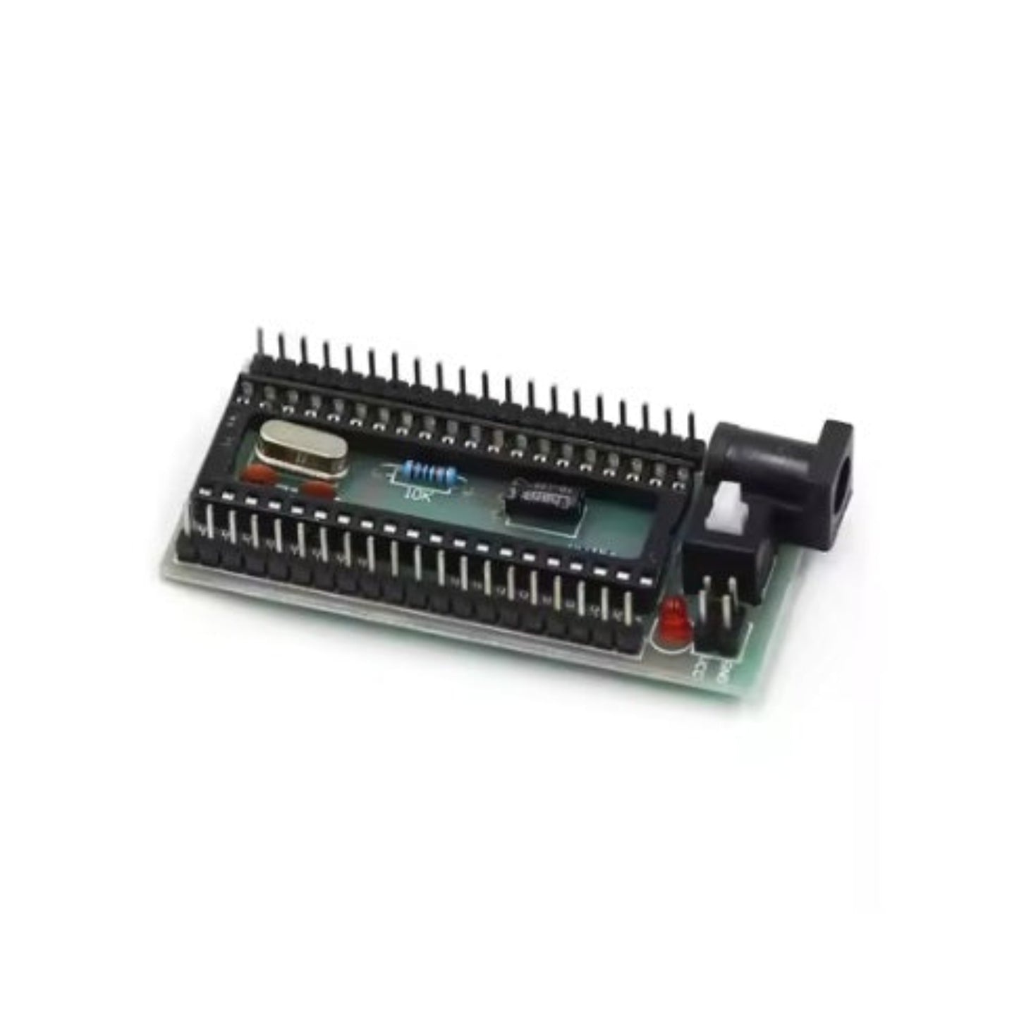 Angled view of 51 MCU minimum system board showing crystal oscillator and power switch.