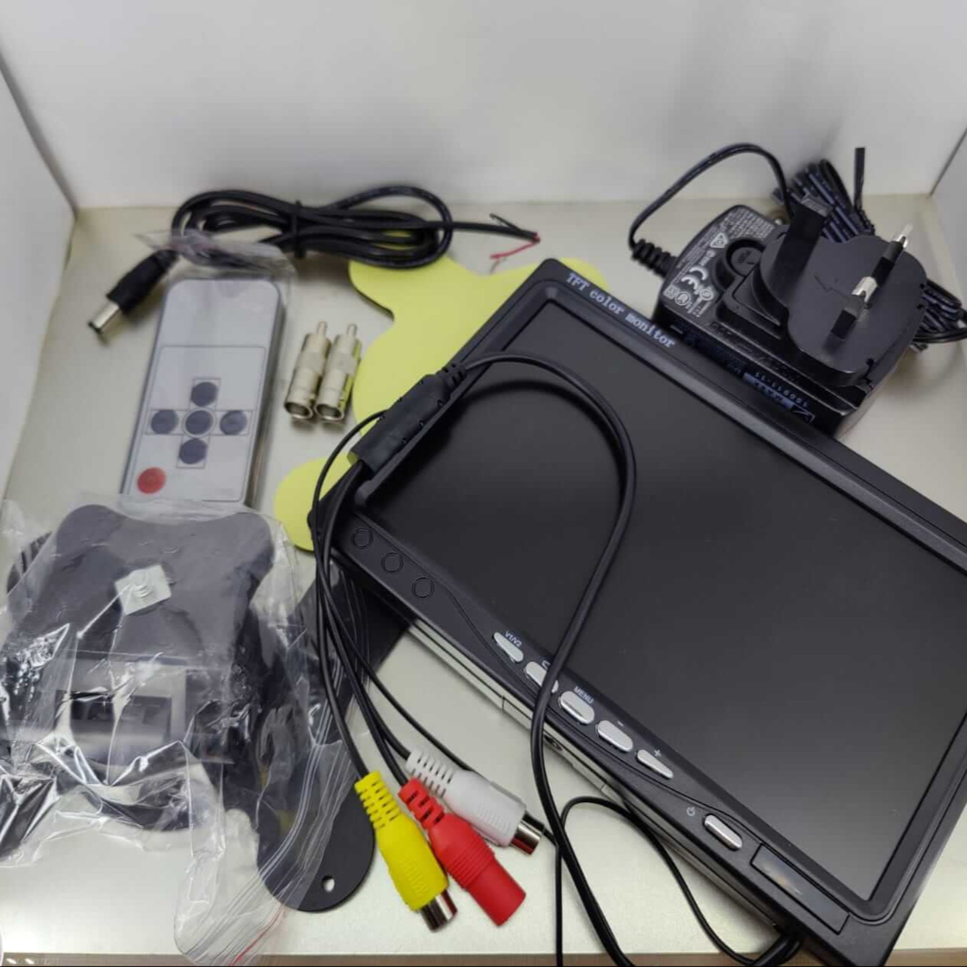 7-inch HD CCTV monitor with accessories including remote and cables for dual video input surveillance system.