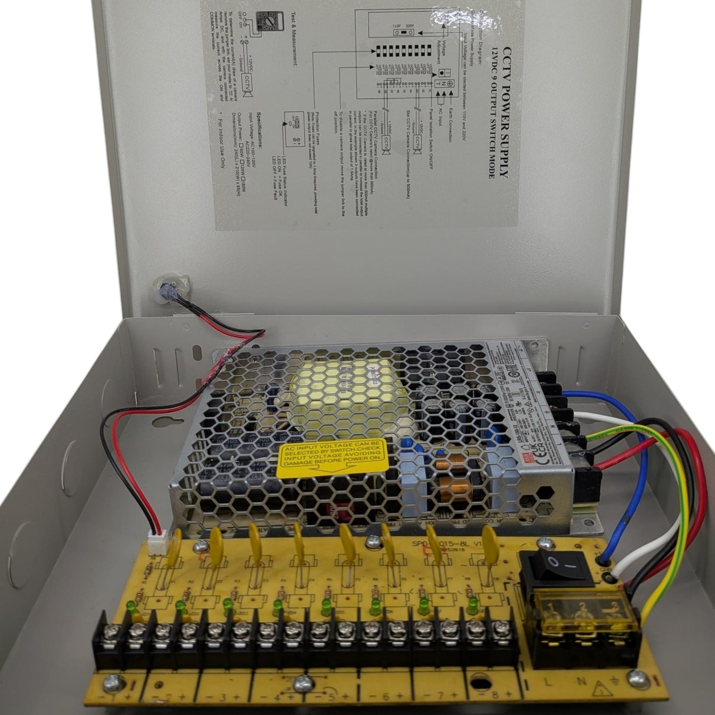 Internal view of the 12V DC security camera power distribution box, highlighting the Mean Well power supply and 8-channel fuse board.