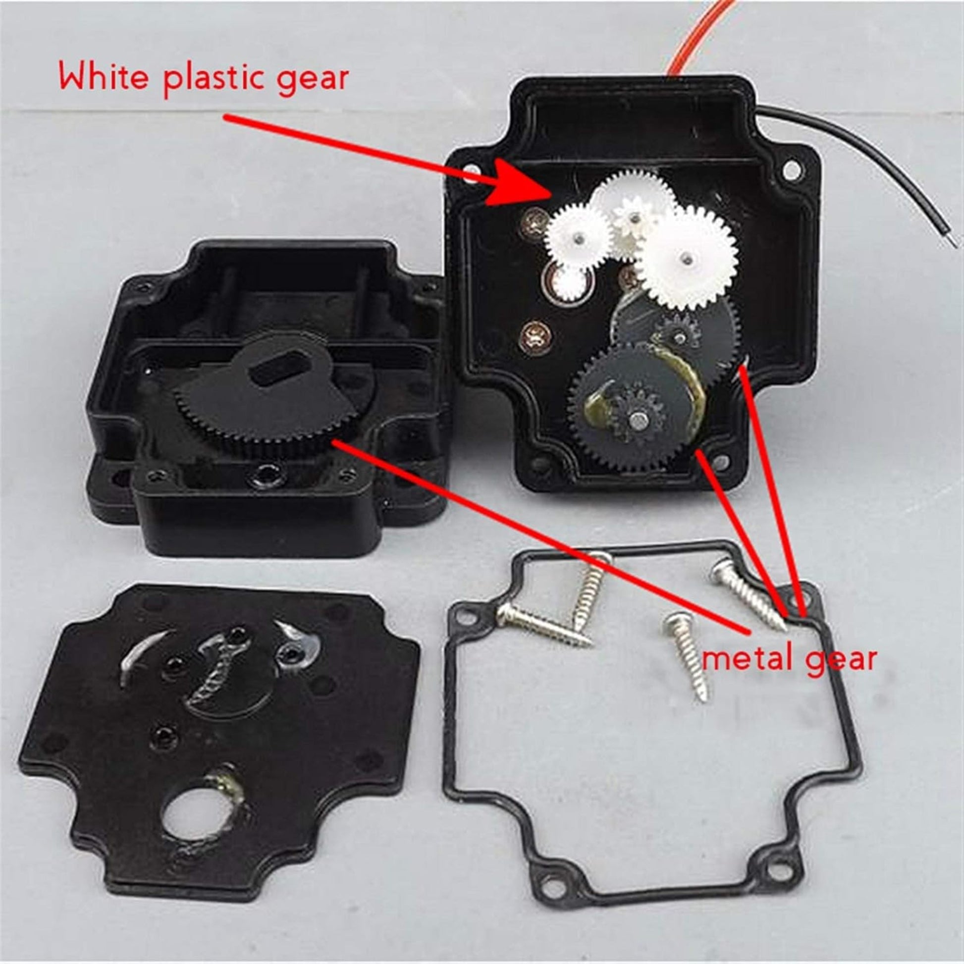 DC 5V motor disassembled view showing white plastic gear and metal gear in gear assembly.