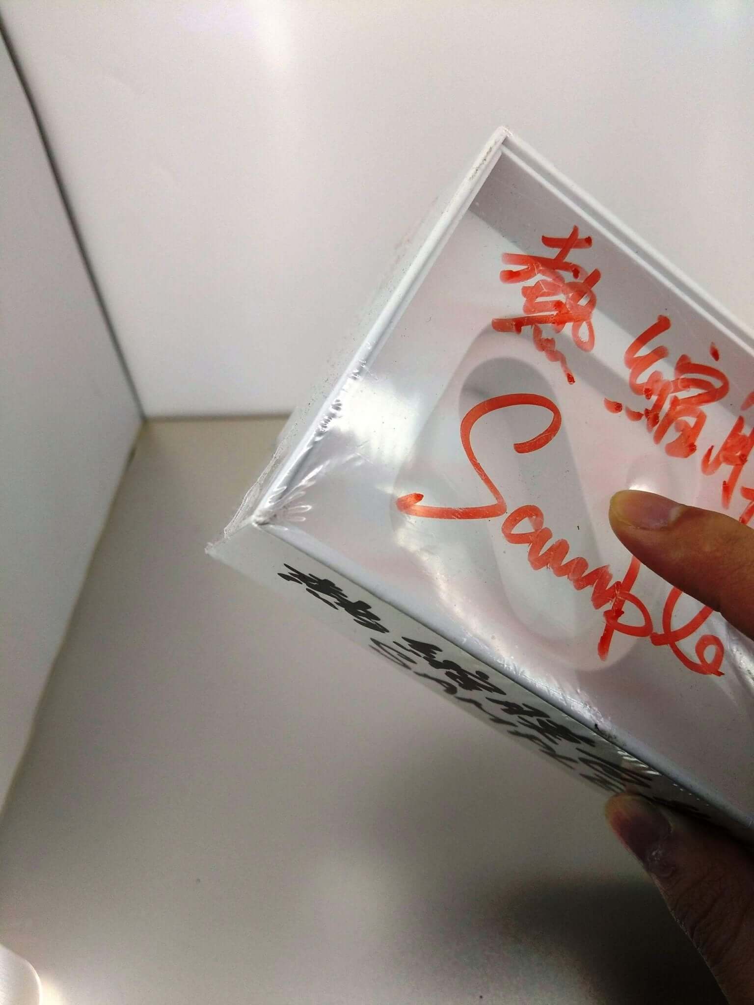 Heat shrink wrap film being used to package a gift or product, showcasing clear, protective wrapping.