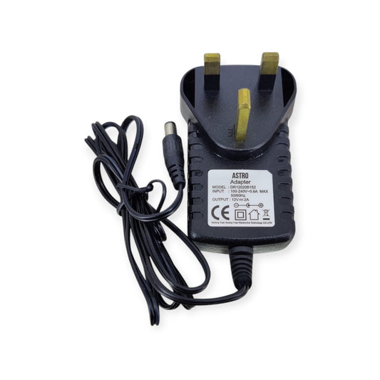 Top-down view of the ASTRO 12V 2A power adapter with a UK plug, showing the technical specifications label.