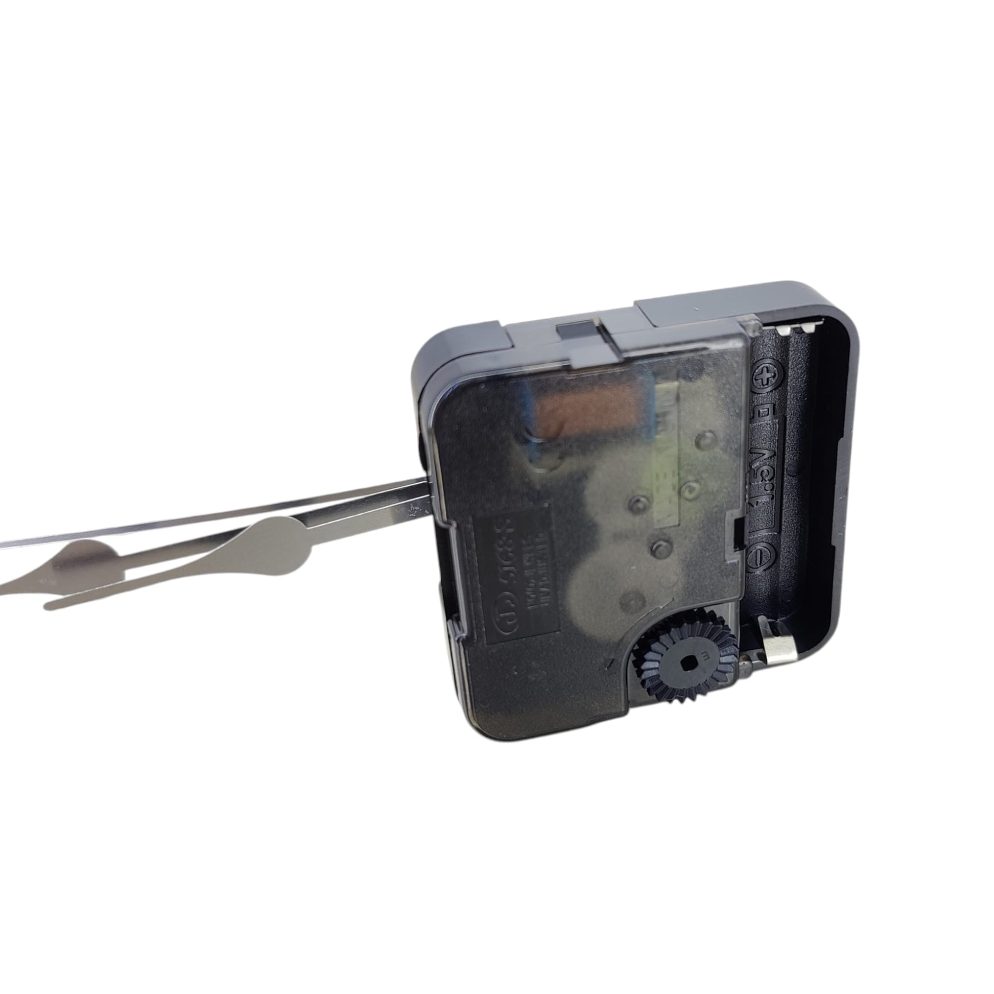 Back view of clock motor showing AA battery slot and time adjustment wheel.