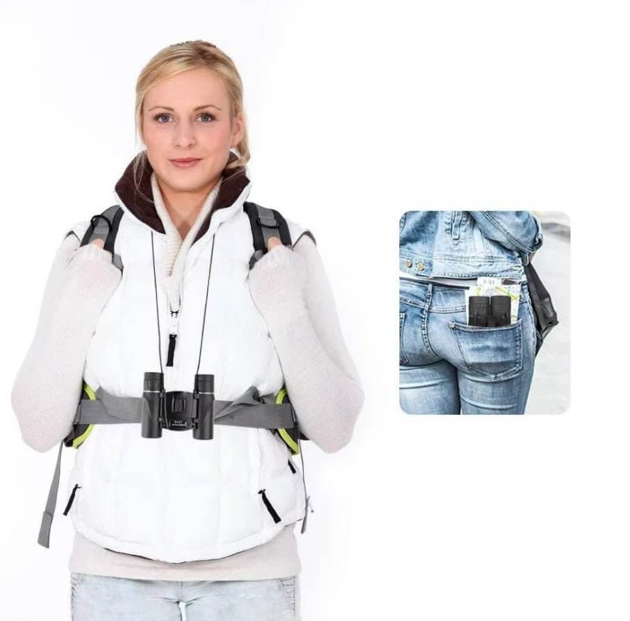 Woman wearing a white vest with binoculars, showcasing compact design for outdoor adventures and activities.