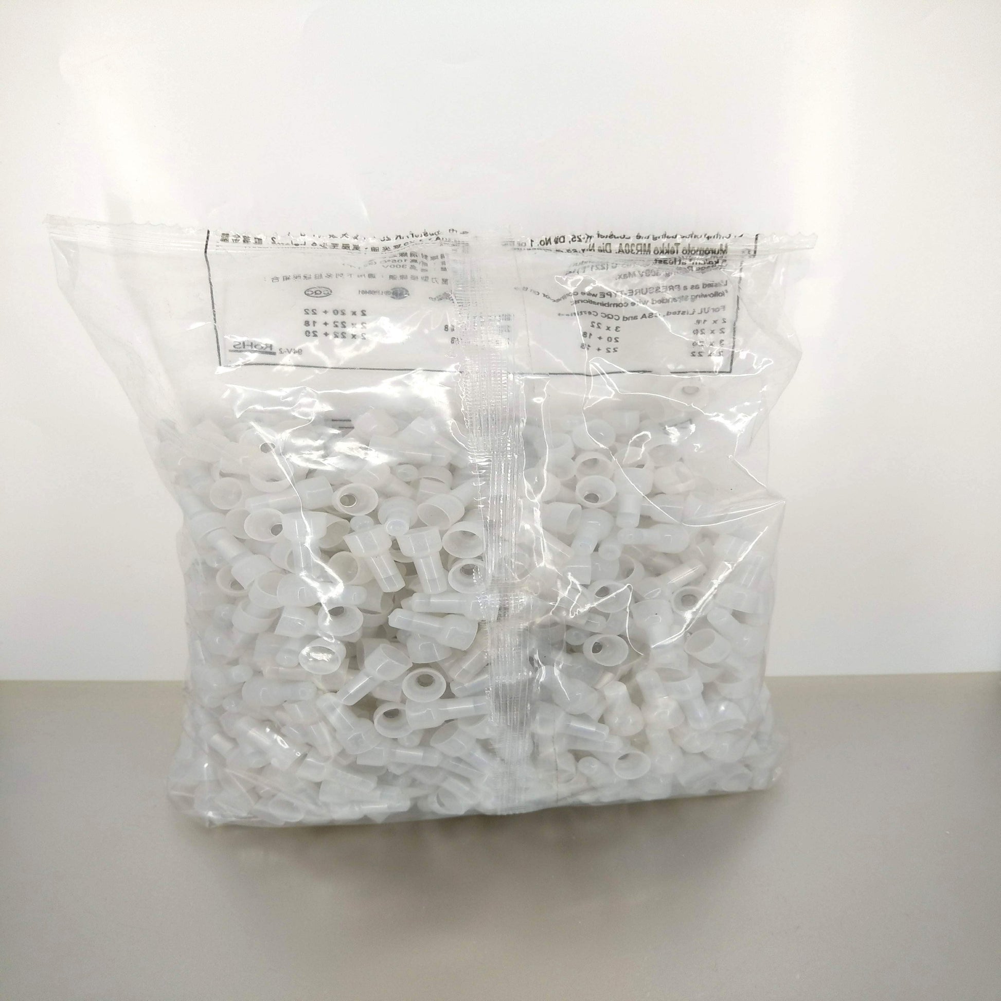 A large bag of 1000 pieces of white CE-2X closed-end wire connectors, showing the product in its bulk packaging.