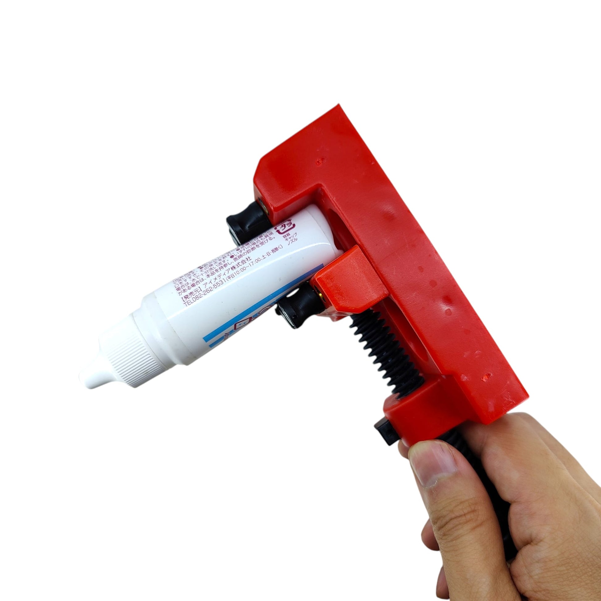 Red mini bench vise securely holding a small tube of adhesive using the adjustable pegs.