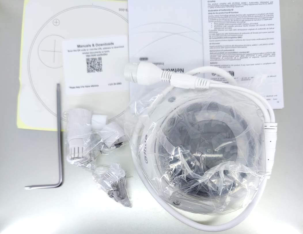 Dahua IPC-HDBW2249E-S-IL camera accessories including manuals, mounting hardware, and protective packaging.