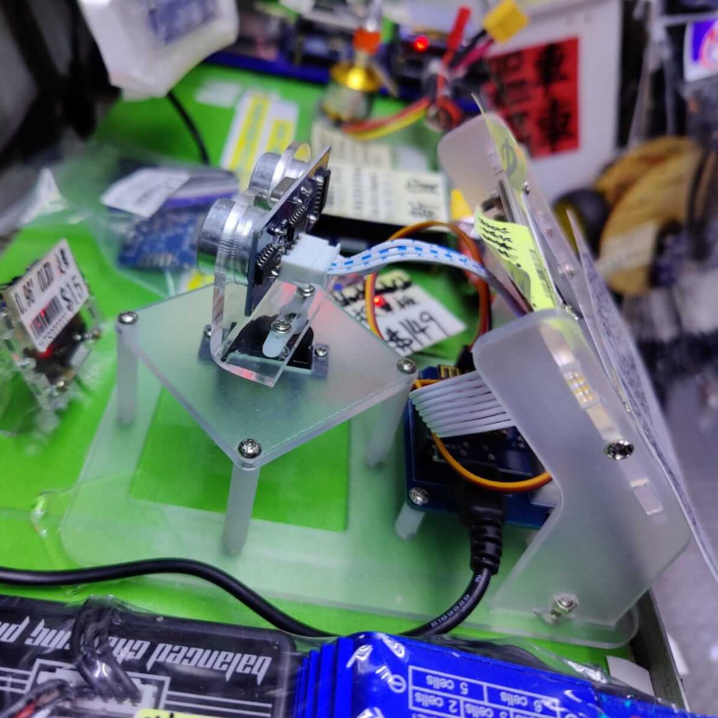 Side view of the assembled ultrasonic sensor module mounted on a servo motor.