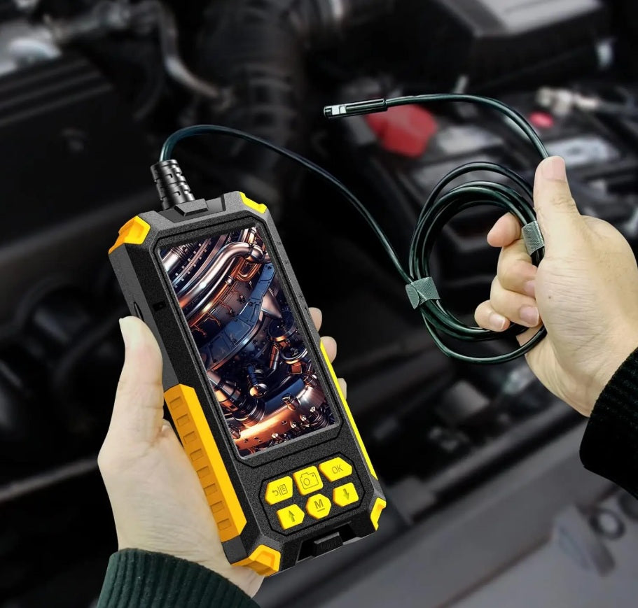 User holding dual lens endoscope camera inspecting car engine automotive