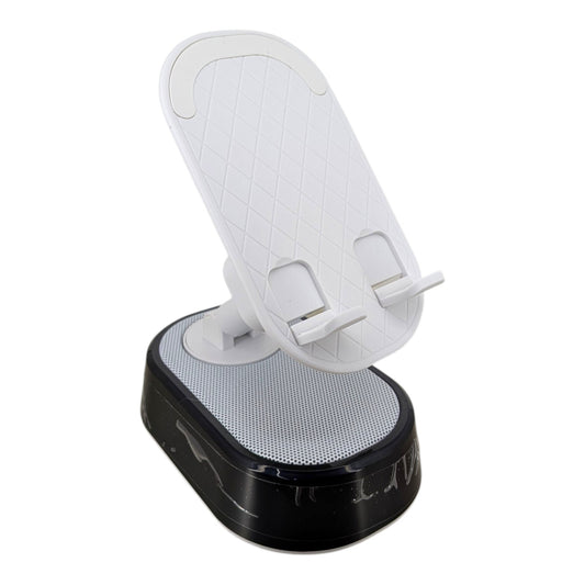 Black foldable phone stand with built-in Bluetooth speaker and glowing RGB ambient light base holding a smartphone.