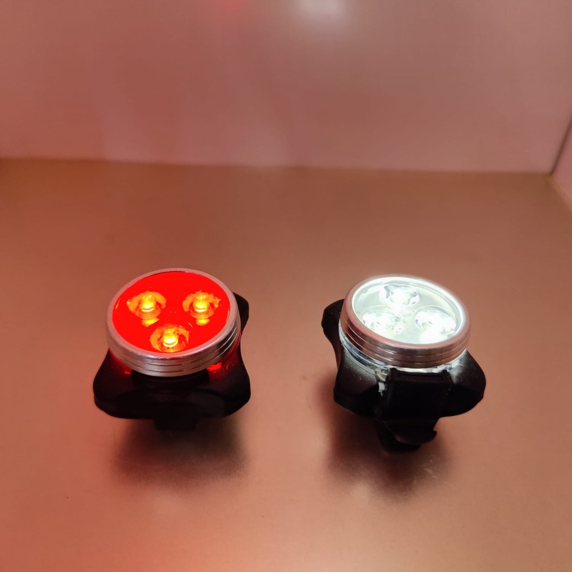 Pair of compact cycle safety lamps featuring 3 high-intensity LEDs in white and red colors.