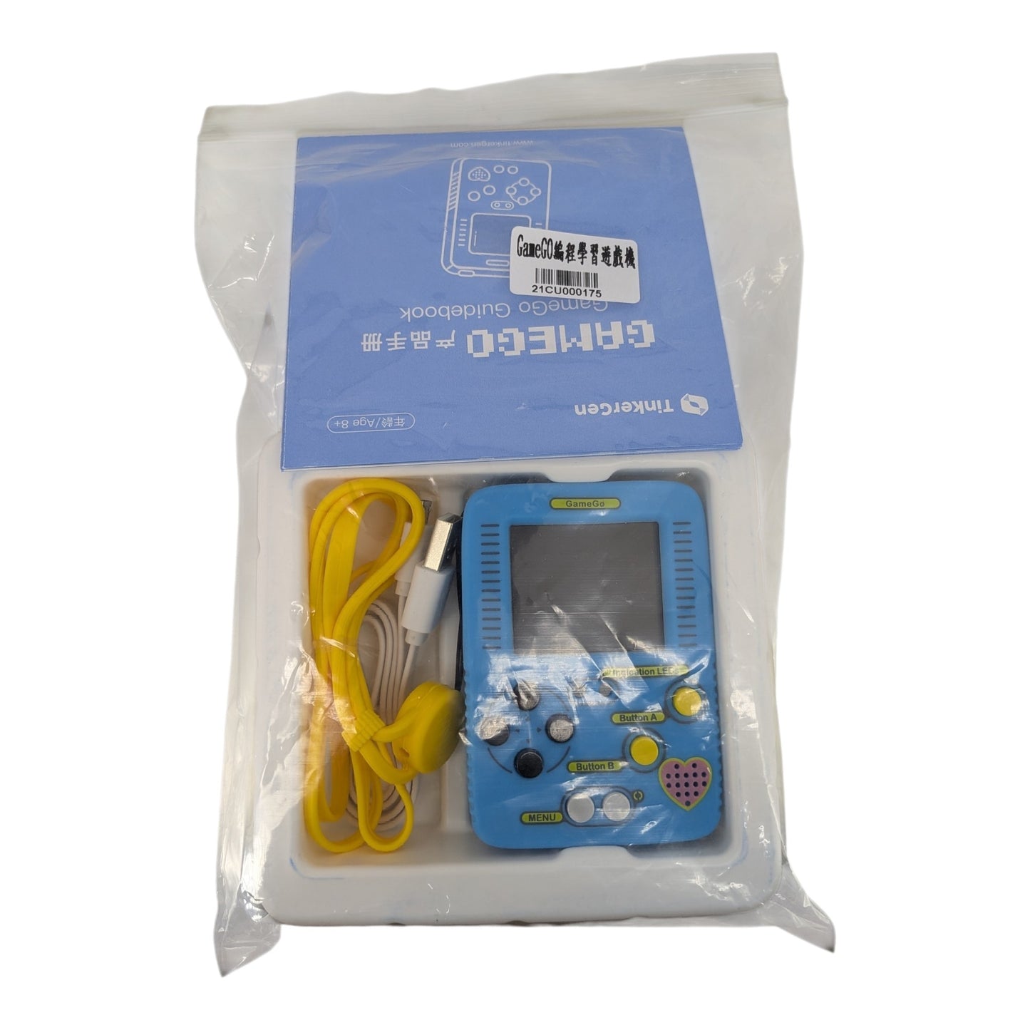GameGo handheld console in clear retail bag packaging with a blue guidebook and a yellow USB cable.