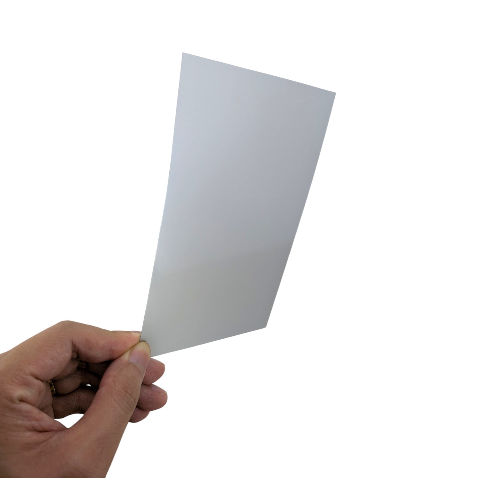 A hand holding the 15x10cm linear polarizing film, demonstrating its slightly tinted optical properties for retro console and dashboard LCD repairs.