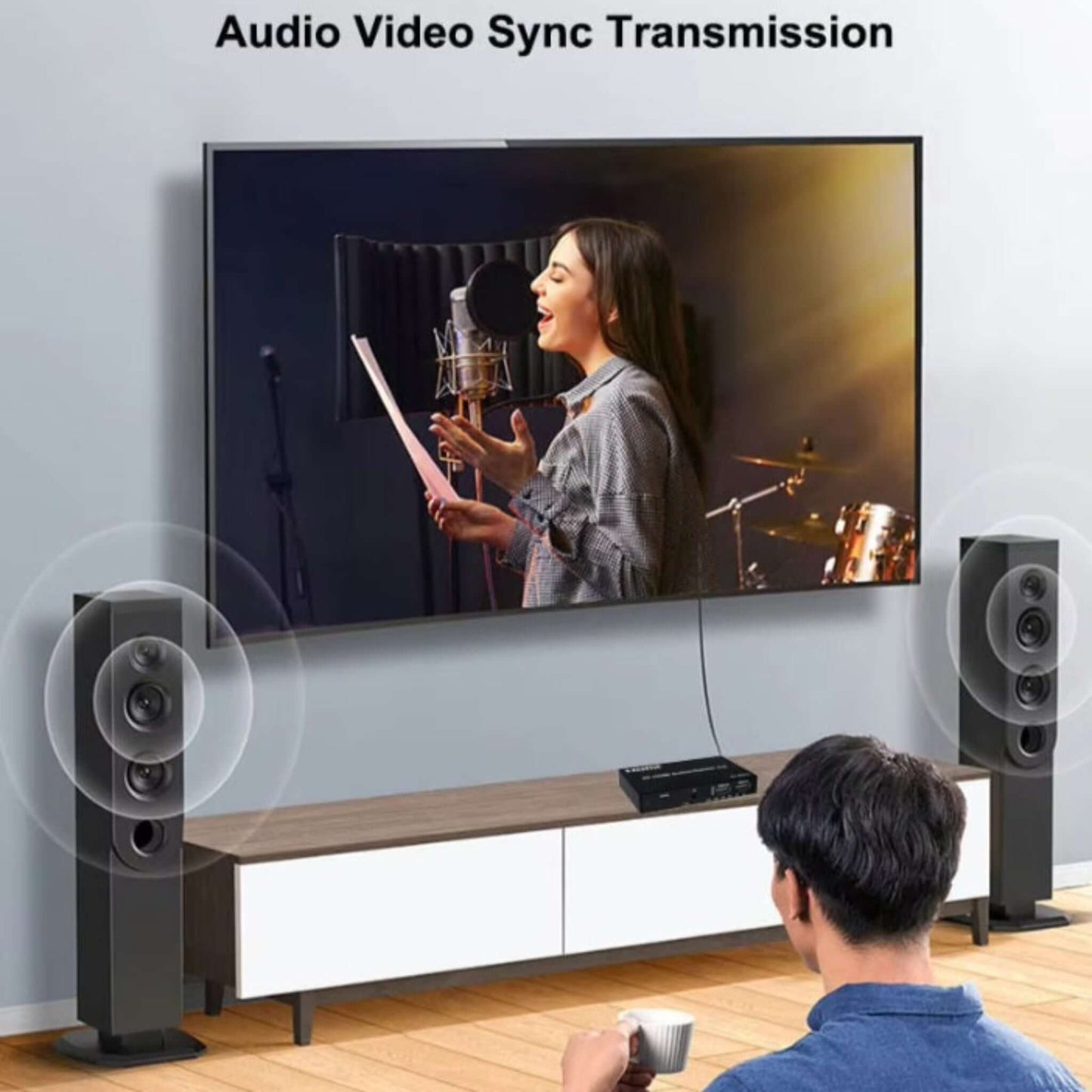 Person enjoying seamless audio video sync transmission on a large screen with speakers, enhancing entertainment experience.