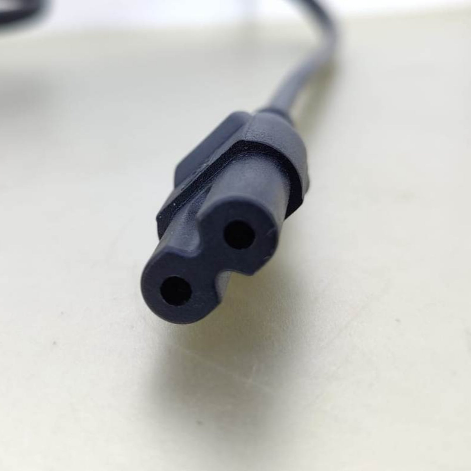 IEC C7 Figure 8 connector, common for electronics like TVs and game consoles