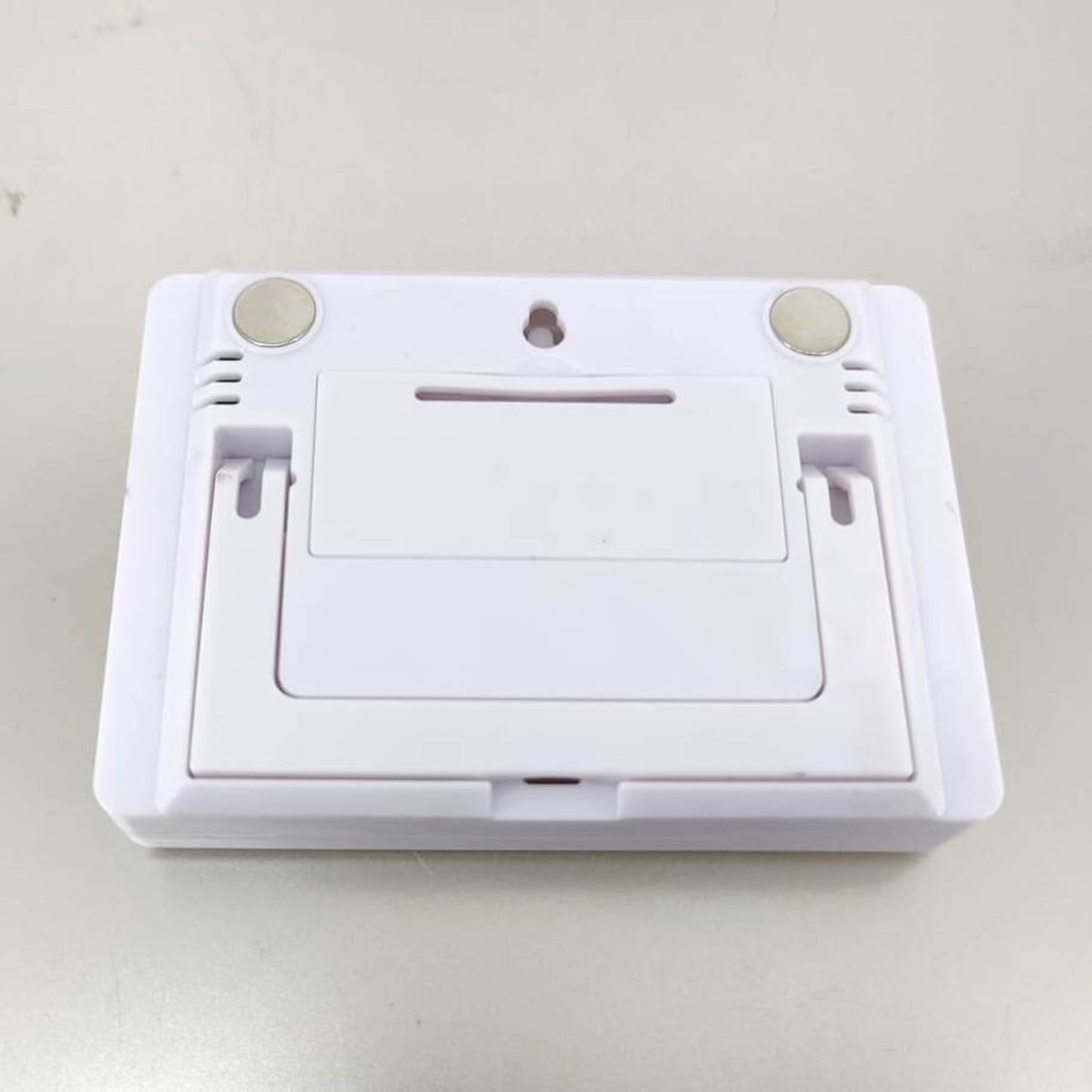 Back of the indoor thermometer and humidity meter: shows the magnetic mounts, wall hanging hole, and foldable kickstand.