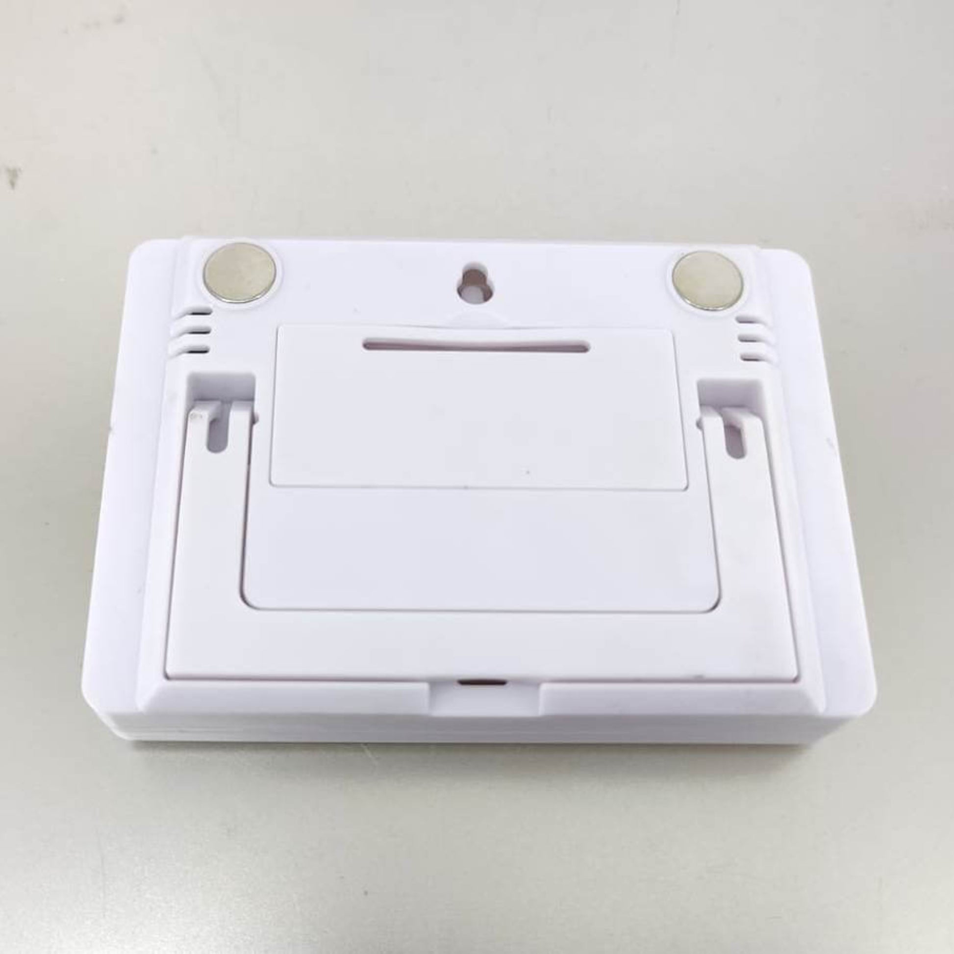 Back of the indoor thermometer and humidity meter: shows the magnetic mounts, wall hanging hole, and foldable kickstand.