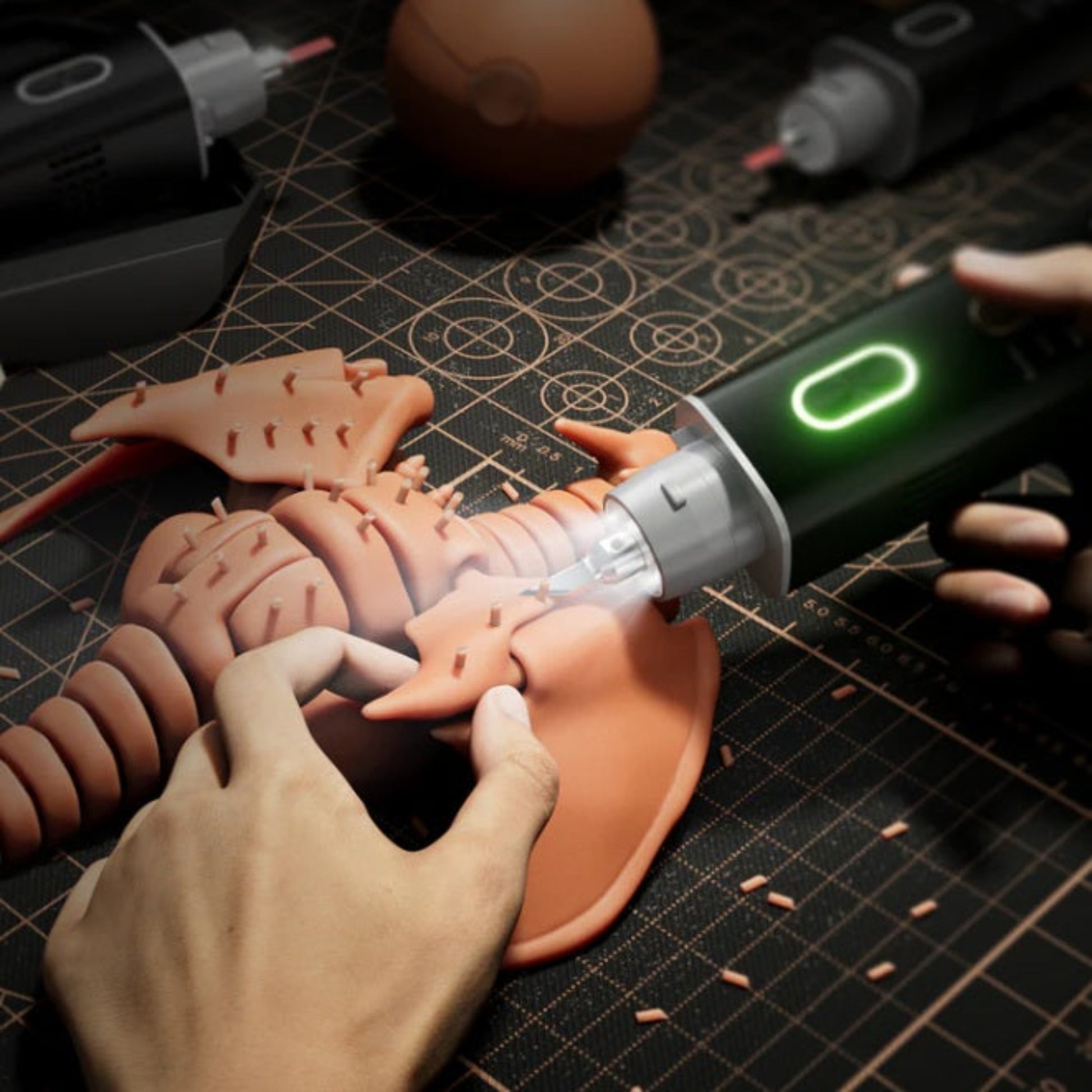 Close-up of a person using a Jakemy ultrasonic cutter to precisely cut and refine a 3D-printed dinosaur model.