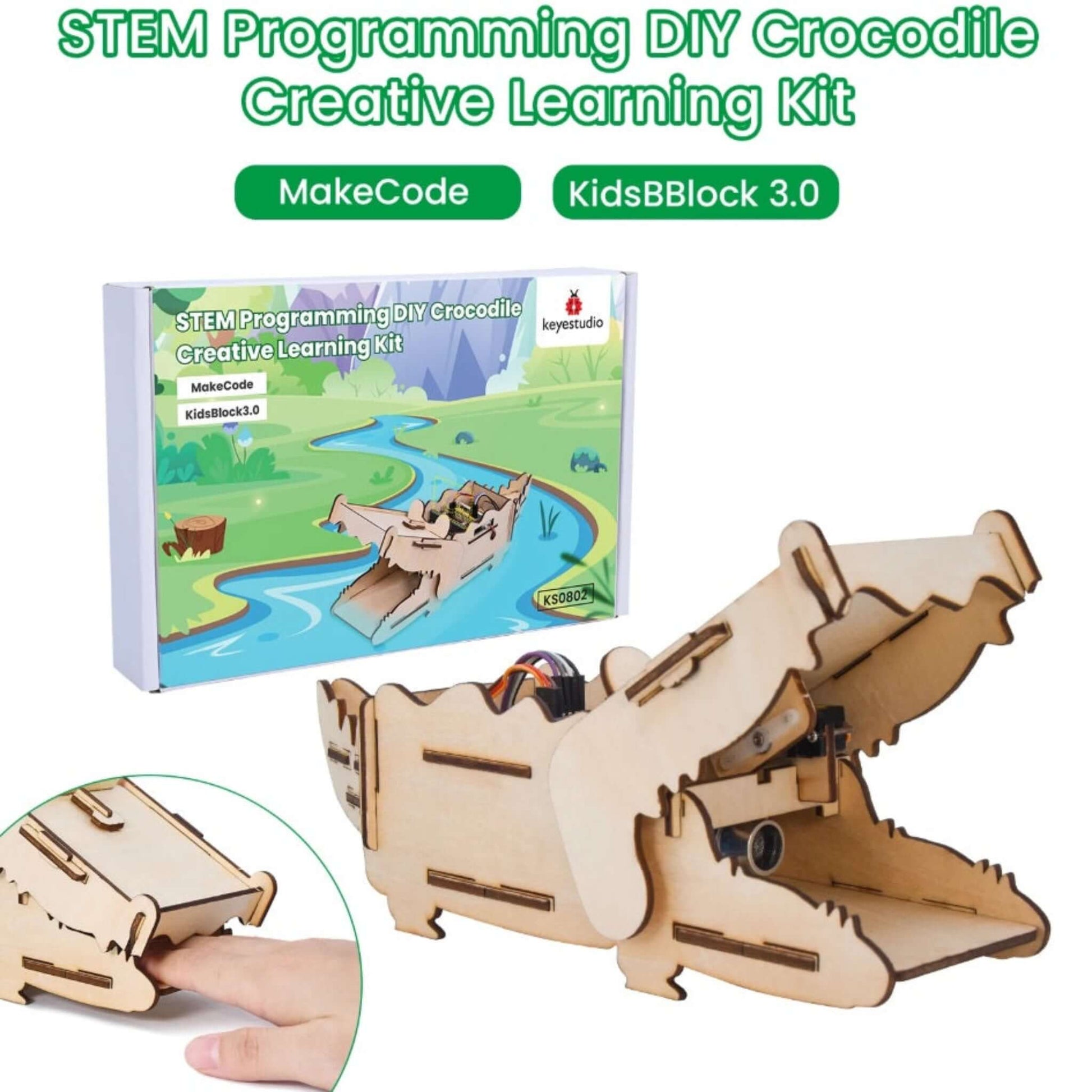 A close-up showing a finger pressing on the crocodile's lower jaw, demonstrating the kit's interactive biting mechanism.