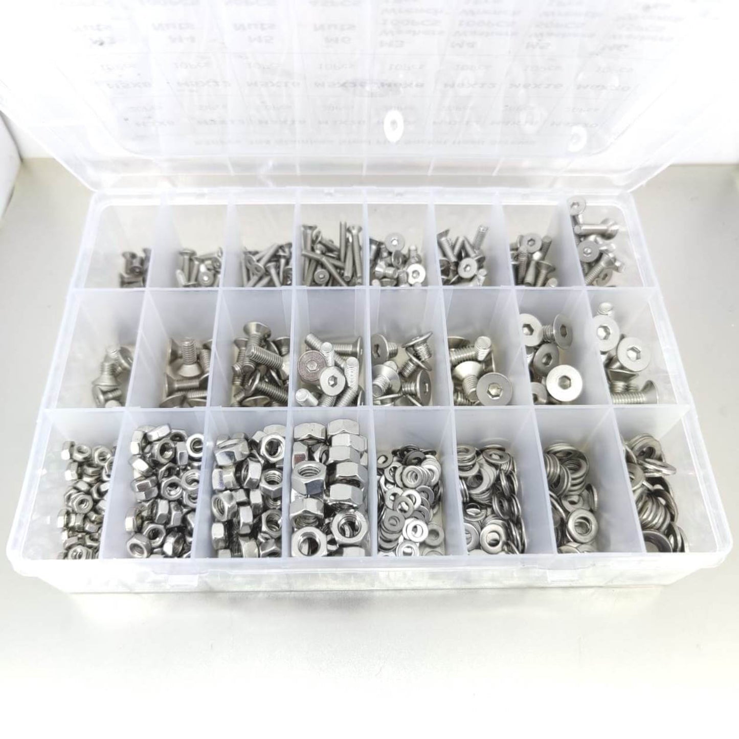 Organized box of metric countersunk bolts, nuts, and washers with hex wrenches.