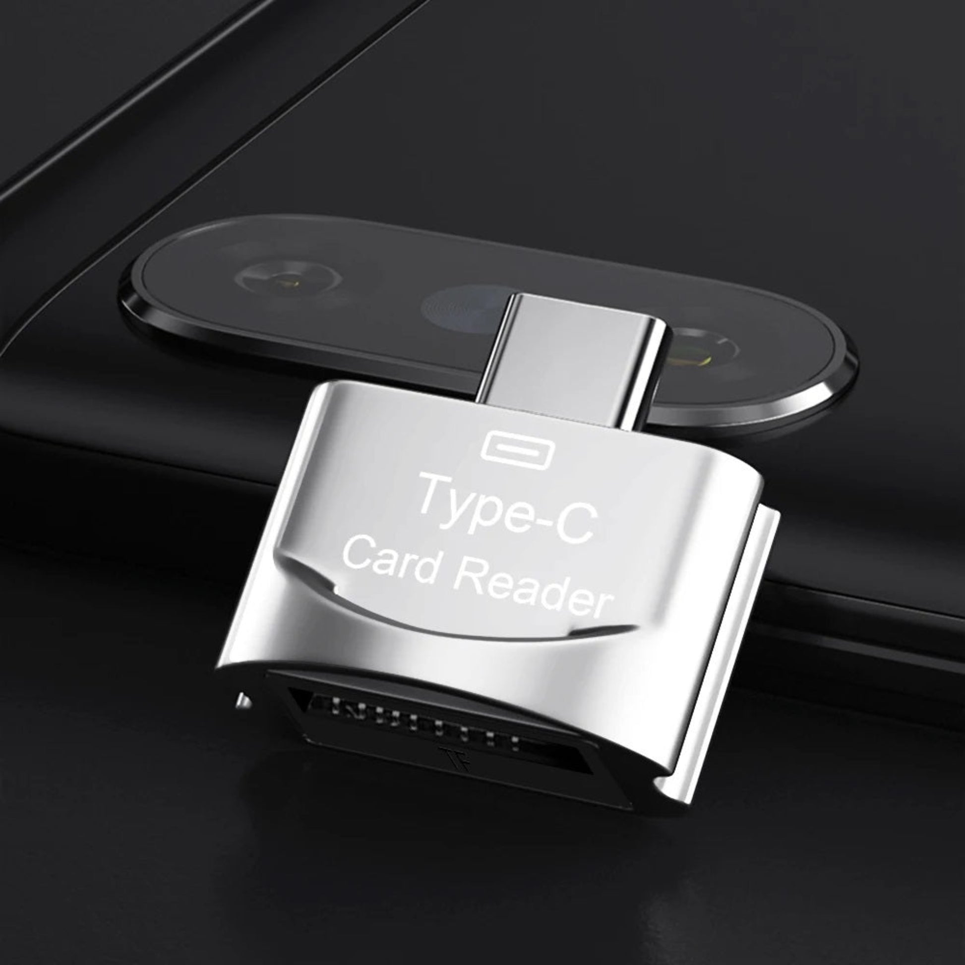 Type-C card reader in silver connected to a smartphone for easy memory card access and data transfer.