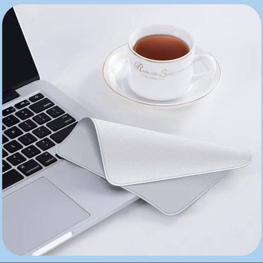 Soft microfiber polishing cloth for Apple devices, placed beside a laptop and tea cup.