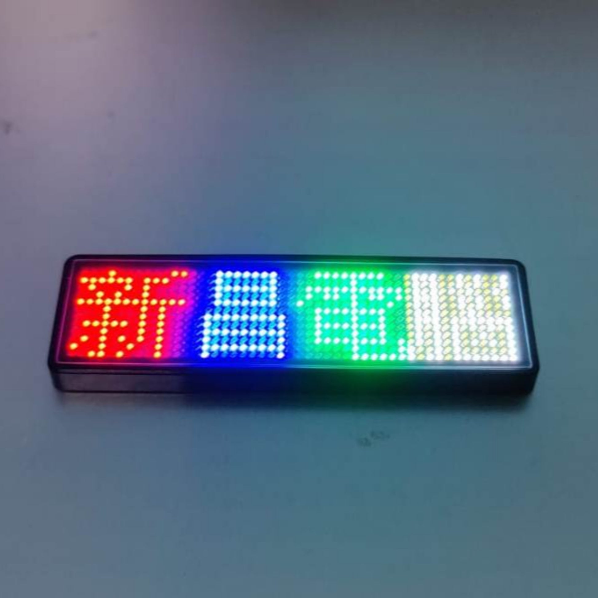 Multicolor Bluetooth LED name badge displaying programmable text, perfect for business use and easy wireless control.