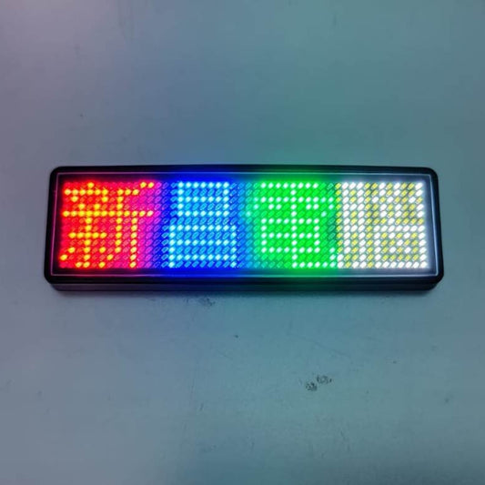 Wireless Bluetooth LED name badge displaying multicolored lights and characters, suitable for programmable use.