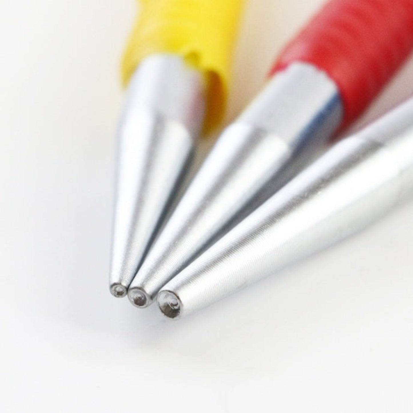 Close up of the precision 40CR-V steel round tips of the nail punch set for woodworking.