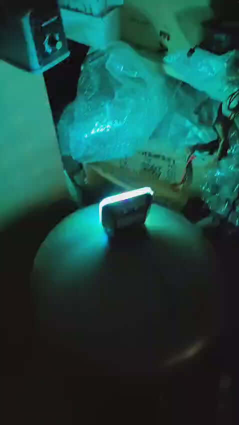 Simulator home security light with flashing blue LED glowing in a dimly lit room.