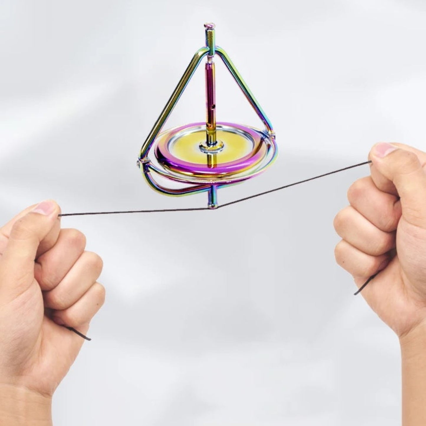 Rainbow metal anti-gravity gyroscope standing upright on its magnetic-style display base