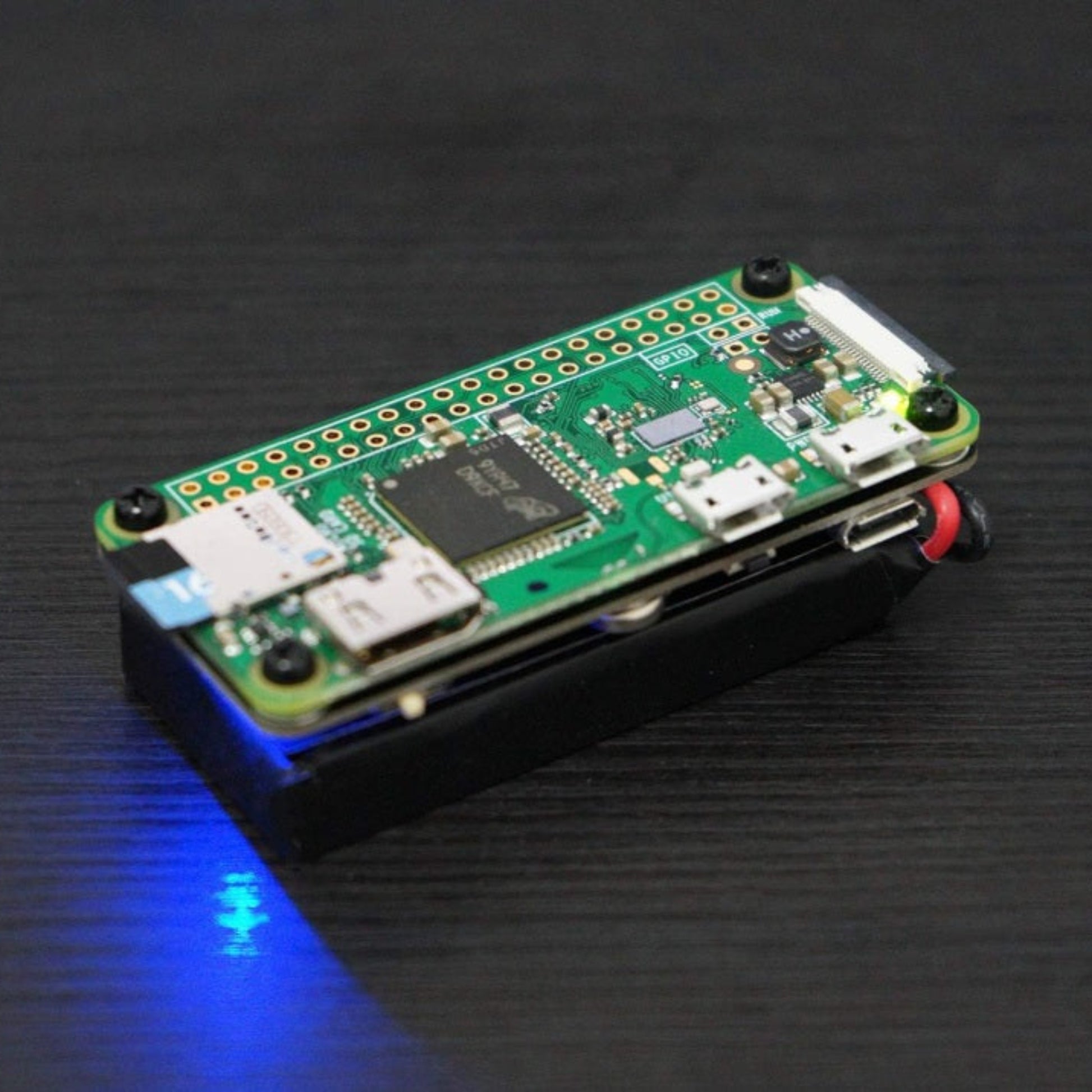 A Raspberry Pi Zero motherboard seamlessly mounted on top of the PiSugar2 solderless battery module with a blue power LED glowing.