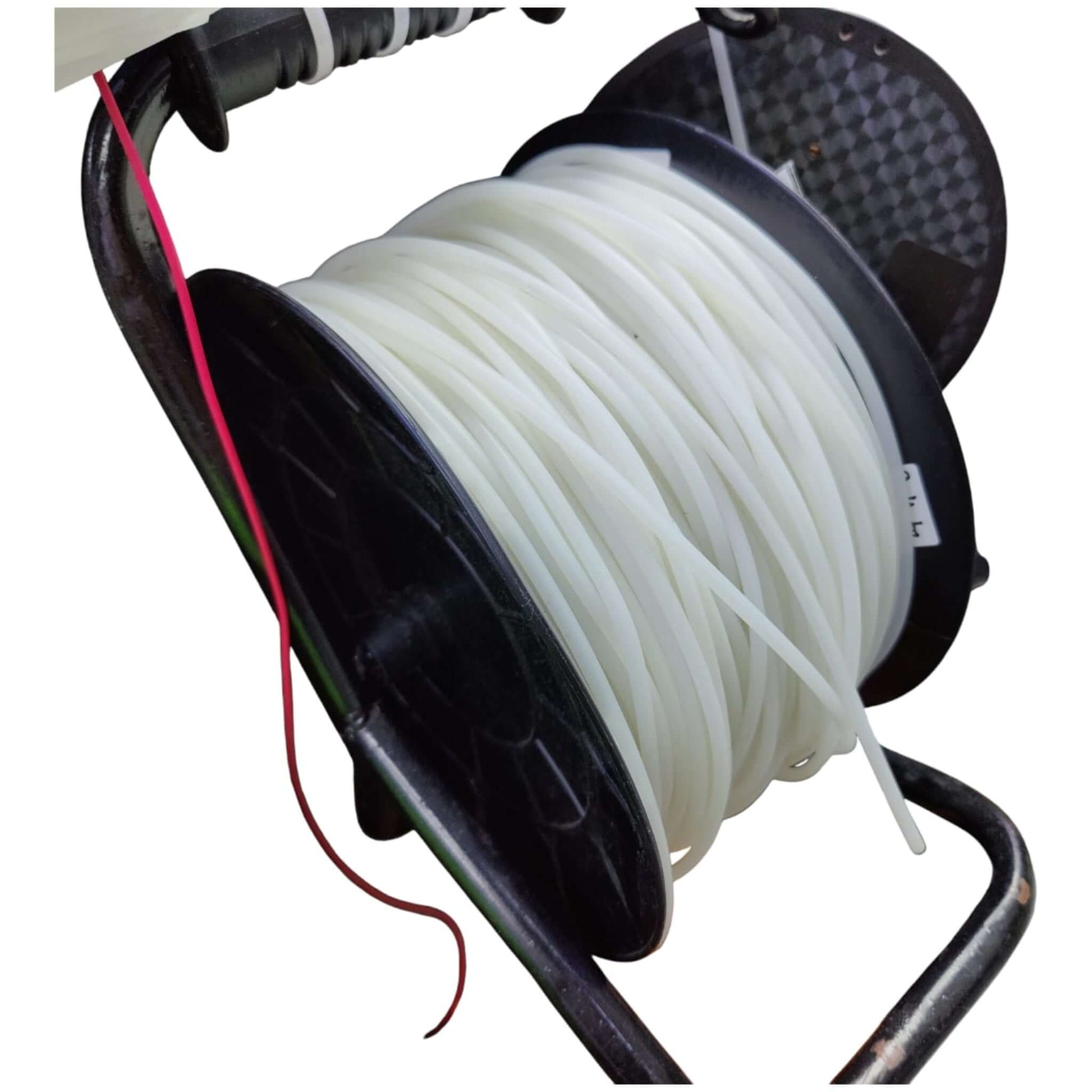 Spool of white thread on a black reel with a red string