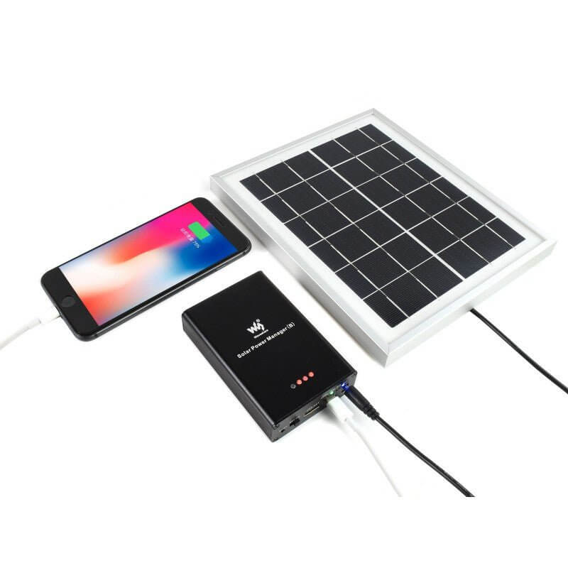Solar Power Manager (B) connected to a solar panel, charging a smartphone outdoors.