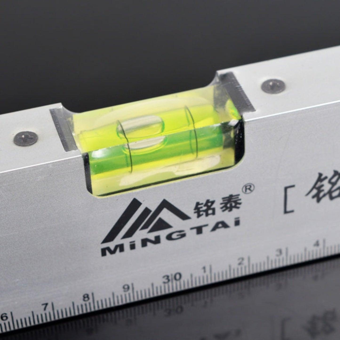 Close-up of high-visibility horizontal bubble vial on a Mingtai aluminum spirit level.