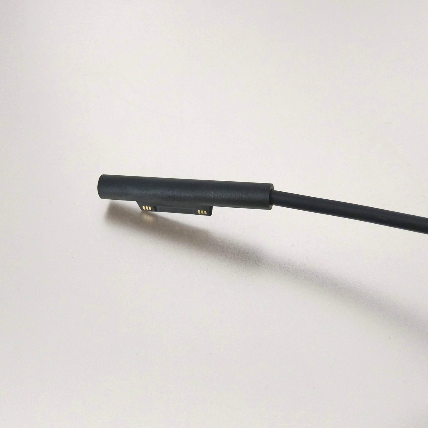 Close-up of the magnetic charging connector for Microsoft Surface tablets.