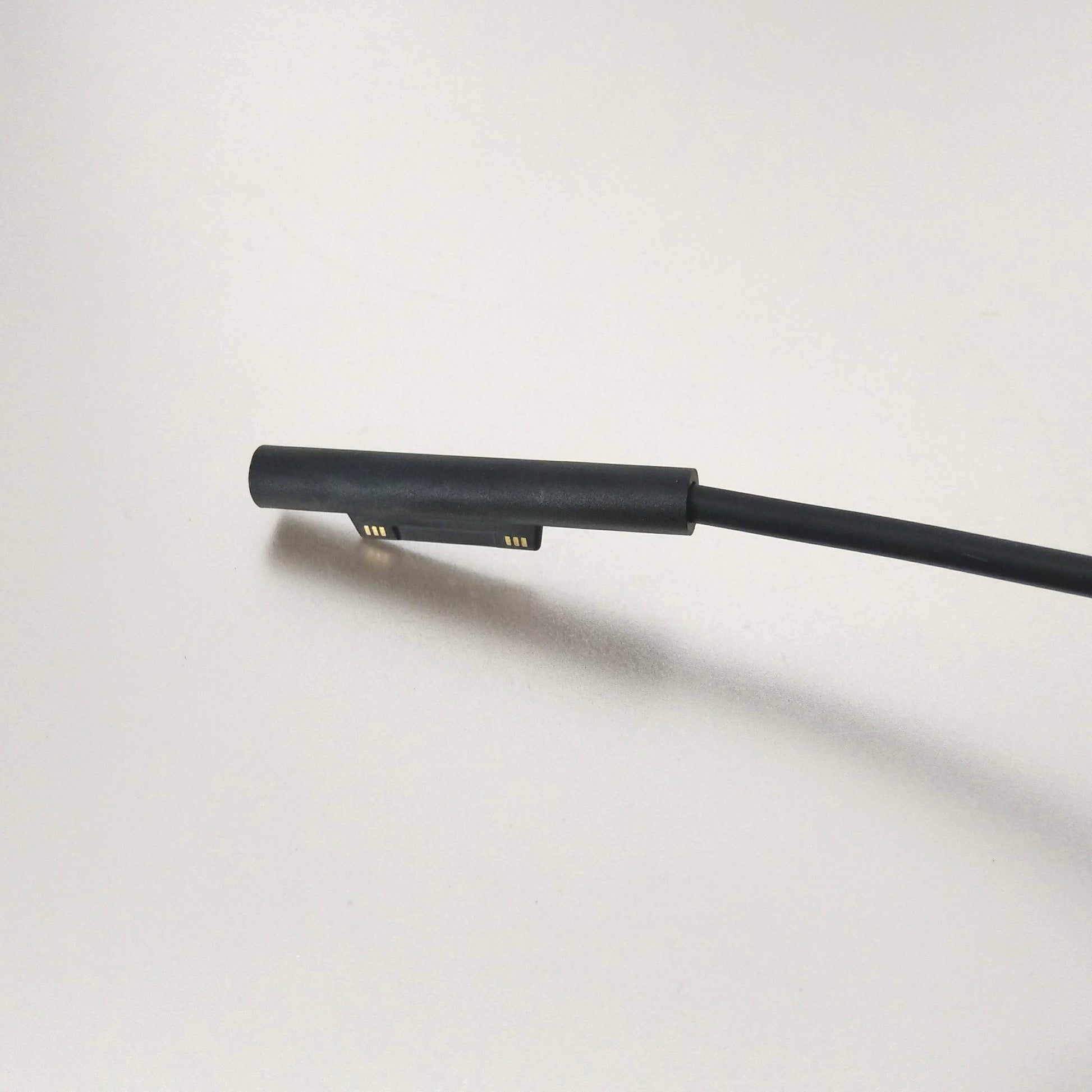 Close-up of the magnetic charging connector for Microsoft Surface tablets.