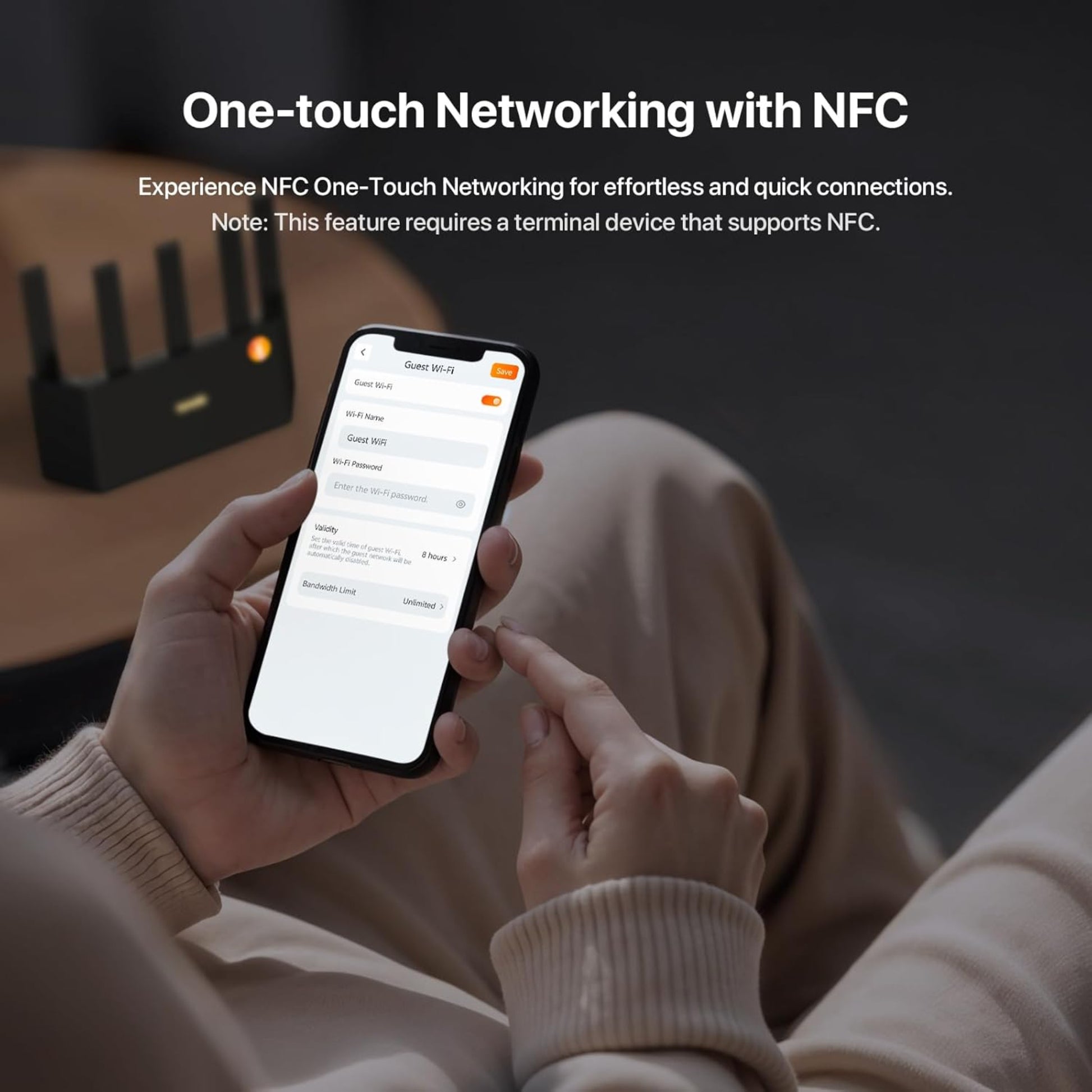 A user demonstrating the one-touch NFC networking by tapping a smartphone on the Tenda BE5100 router.