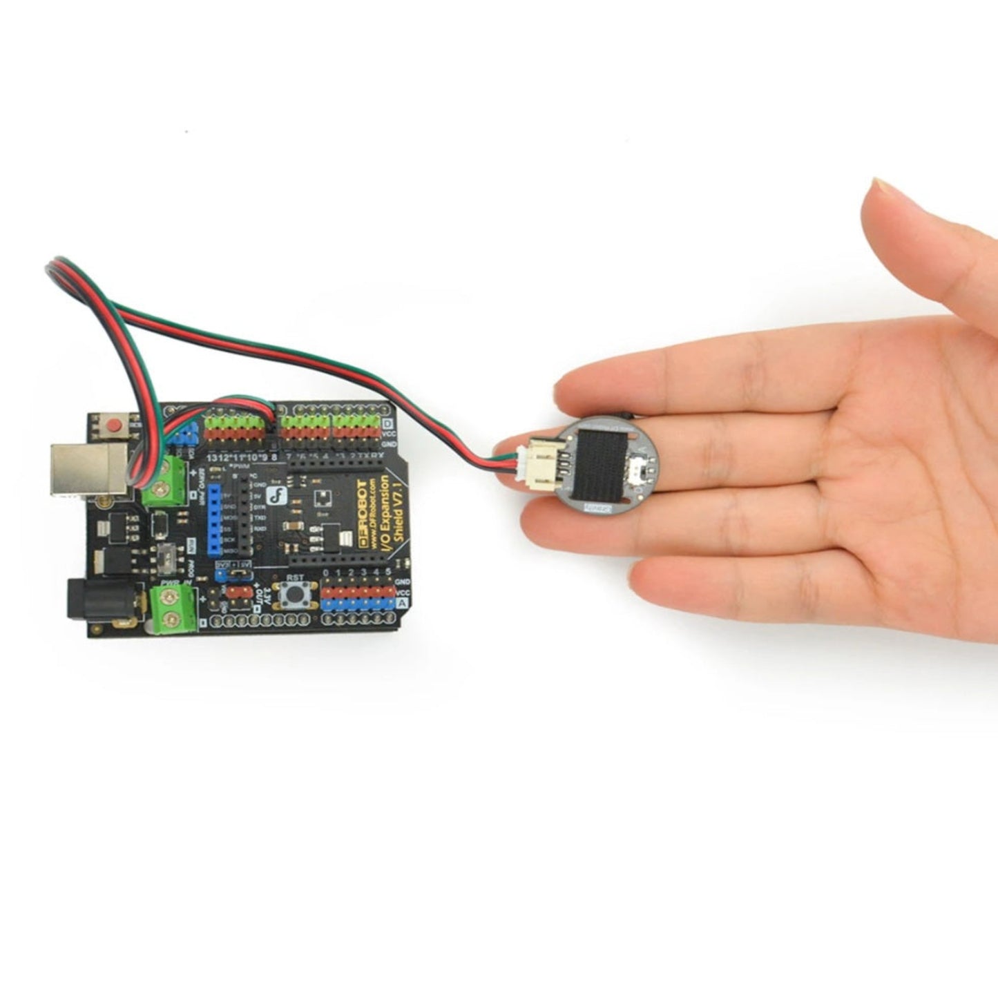 The compact, thumb-sized Gravity PPG pulse sensor strapped to a user's finger for accurate resting heart rate detection.