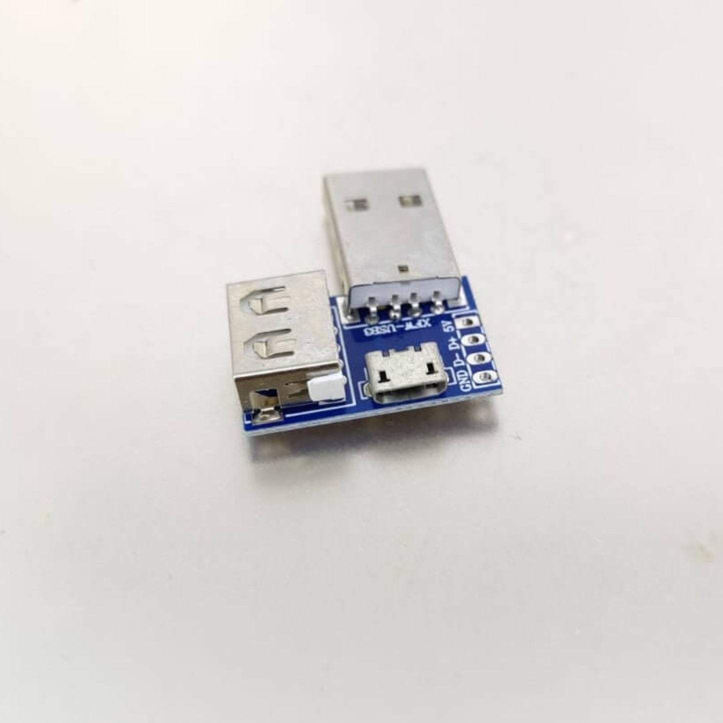 USB adapter board with USB-A male, USB-A female, and Micro USB ports for versatile connectivity.
